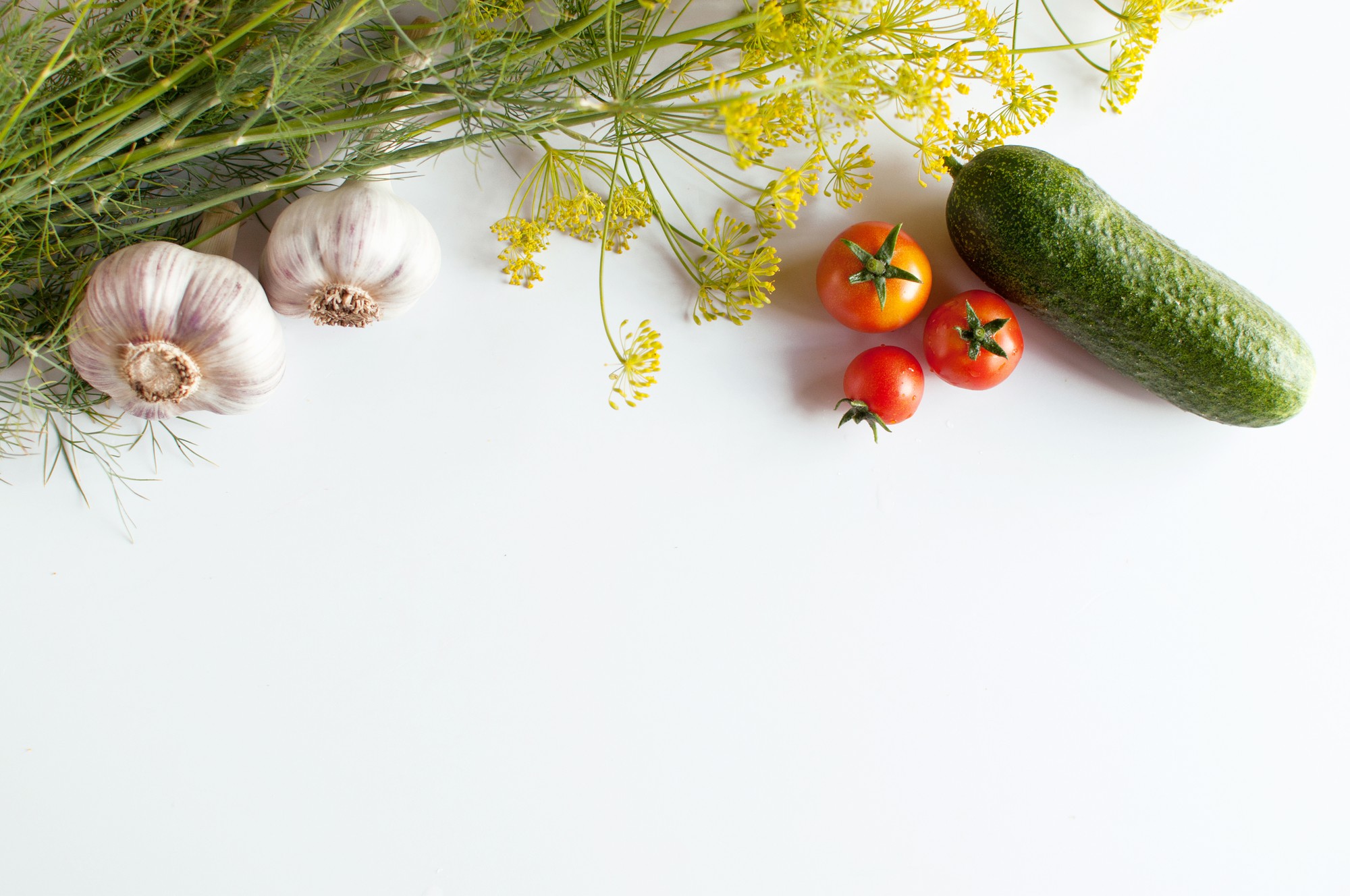 Flatlay of seasonal vegetables and herbs on a table