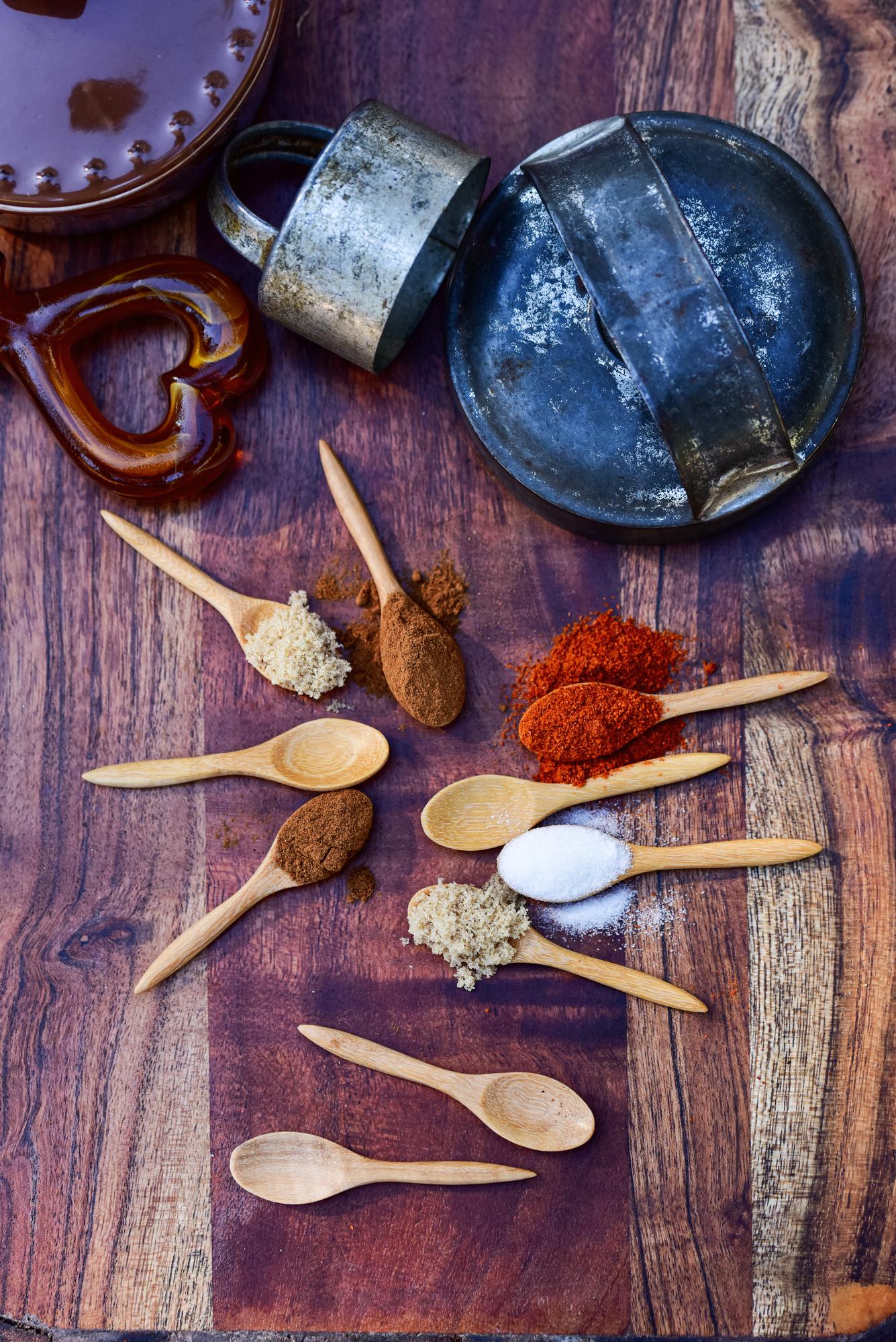 Closeup of spice jars and wooden spoon